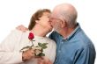 Happy Senior Couple Kissing with Red Rose