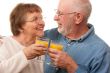 Happy Senior Couple with Glasses of Orange Juice