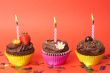 Miniature chocolate cupcakes with candles