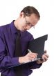 Businessman writing on clipboard