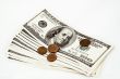 Hundred dollar bills and coins