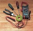 Electrician tools on wooden surface