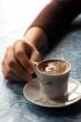 holding cup of coffee