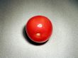 A single tomato on the table surface
