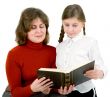 Woman and girl reads a book