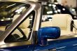 Right side mirror of shiny blue car