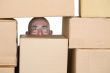 Man looking through pile of cardboard boxes