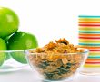 cornflakes, glass of milk and green apples