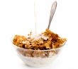 milk pouring onto cornflakes