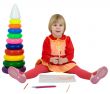 Little girl and toy pyramid and crayons