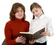 Woman and girl reading book