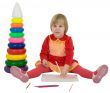 Little girl and crayons and toy pyramid