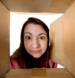 Female portrait through  cardboard box