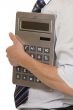 Businessman with gigantic pocket calculator