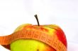 apple and measuring tape isolated on white background