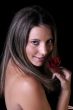 Beautiful young brunette woman with red rose