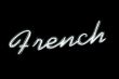 Neon sign with the word `french` over black