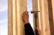 Hispanic carpenter pounding a nail