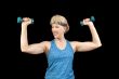 Attractive baby-boomer exercising with weights