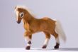 Friendly horse toy prancing on white