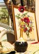gobelin picture with red flowers near it