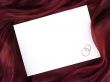 white frame in silk and two wedding rings