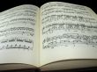old vintage sheet music book over black background