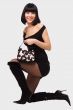 Smiling young woman in little black dress
