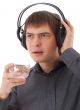young man in headphones drinking water