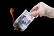 burning paper currency close up