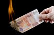 burning paper currency closeup