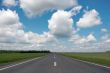 countryside asphalt road under cloudy blue sky