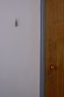 Wooden door and grey wall with a key