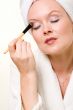 Putting on eye makeup