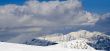 Snowy mountains in clouds with an interesing tints amd shadows