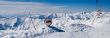 Snowy mountains in clouds with tints of blue and stop sign