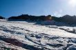 The picturesque mountain view with snow, sky and patch of sunlig