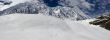 The picturesque mountain view with clouds, stones, peak and snow