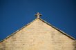 stone cross over triangle covering