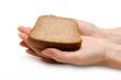 Piece of the pumpernickel in woman hands