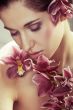 Beautiful young woman with orchid flowers