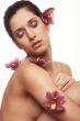 Beautiful young woman with orchid flowers
