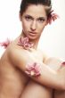 Beautiful young woman with orchid flowers