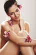 Beautiful young woman with orchid flowers