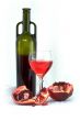 Glass of wine, bottle and a red pomegranate