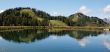 Two hills reflecting in pond