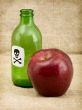 Bottle with poison and an apple