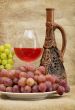 Ceramic bottle, grapes and red wine