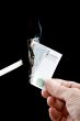 burning money with cigarette