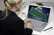 Woman In Kitchen Using Laptop